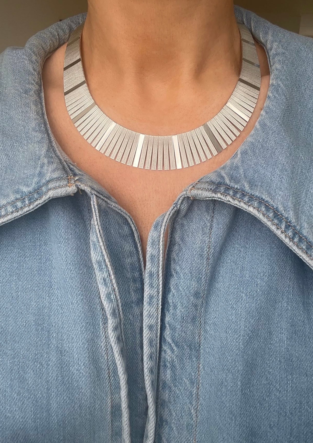 Vintage silver Cleopatra fringe collar necklace worn over a denim shirt