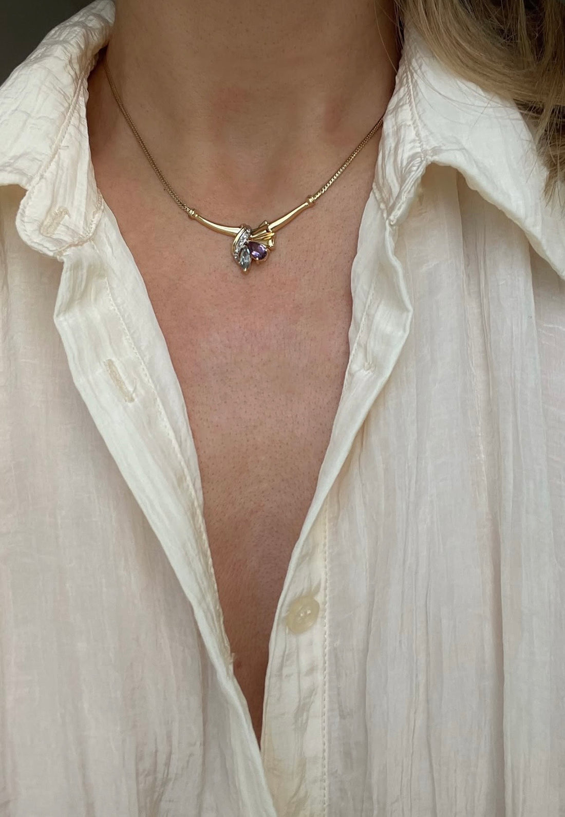 The amethyst and topaz necklace worn, the pendant sitting right at the collarbones