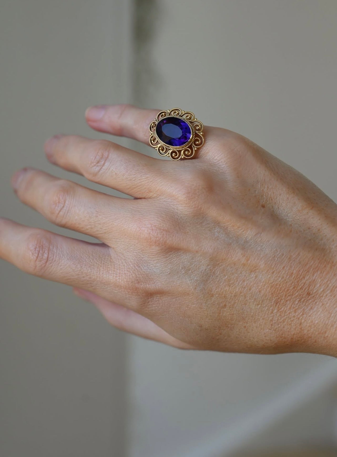 The antique filigree ring worn on the hand