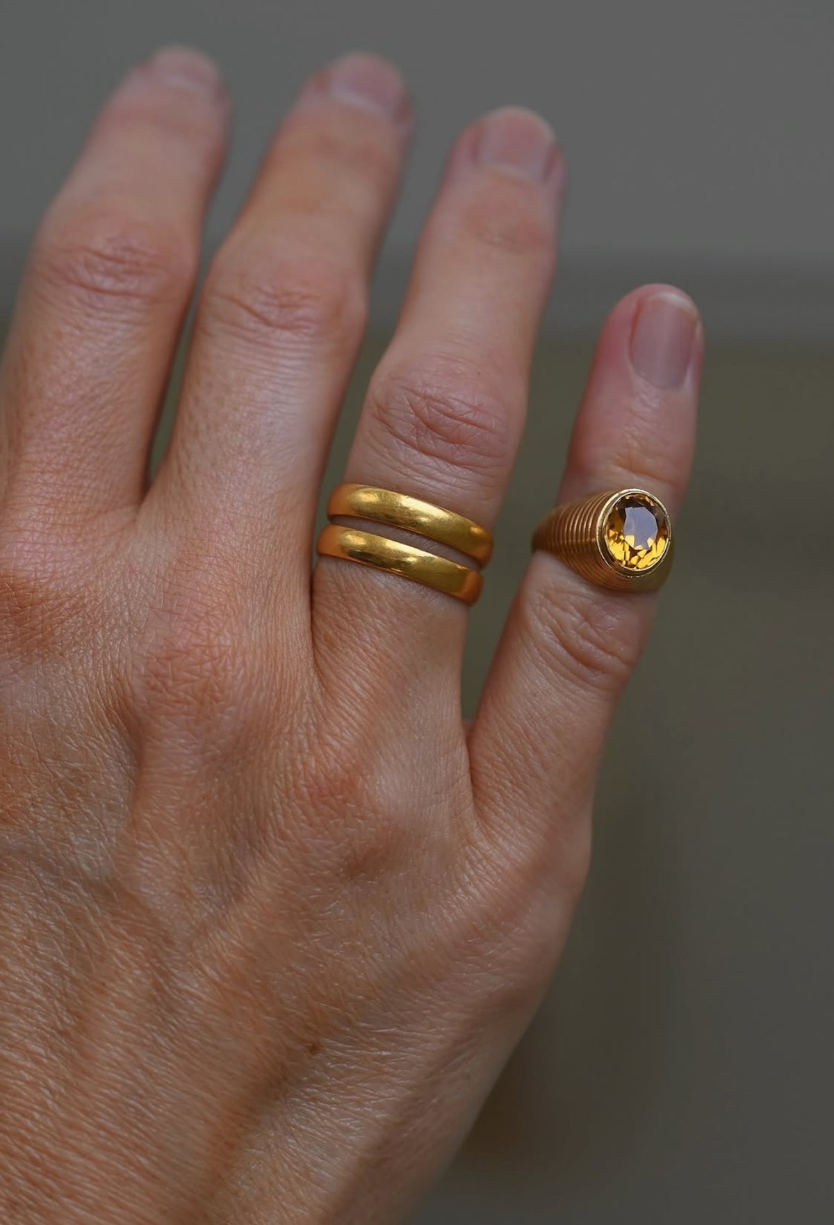 The citrine ring worn on the pinky, styled with stacked gold bands