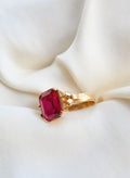 Antique cherry red lab created ruby ring from 1923 in 18K gold, resting on ivory silk